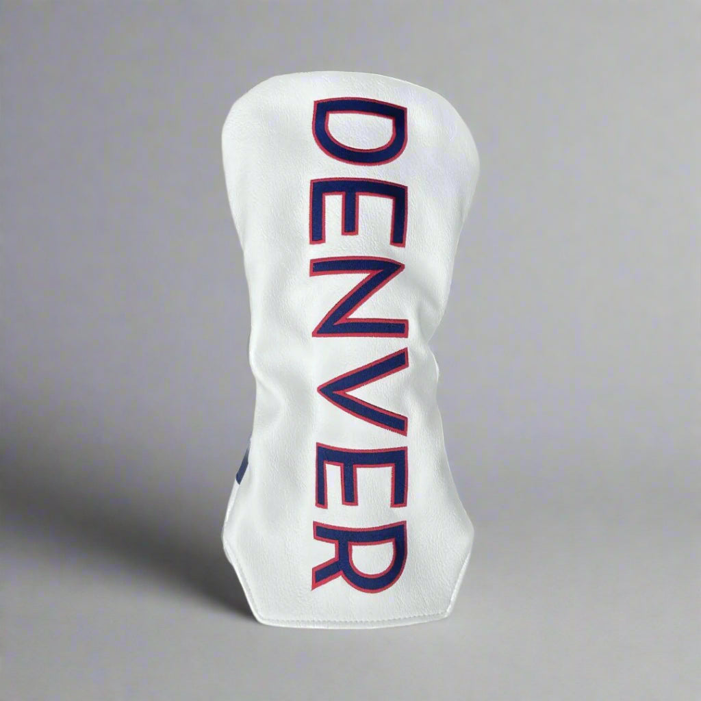 A white golf driver head cover with 'DENVER' written in bold blue letters with a red stitched outline.